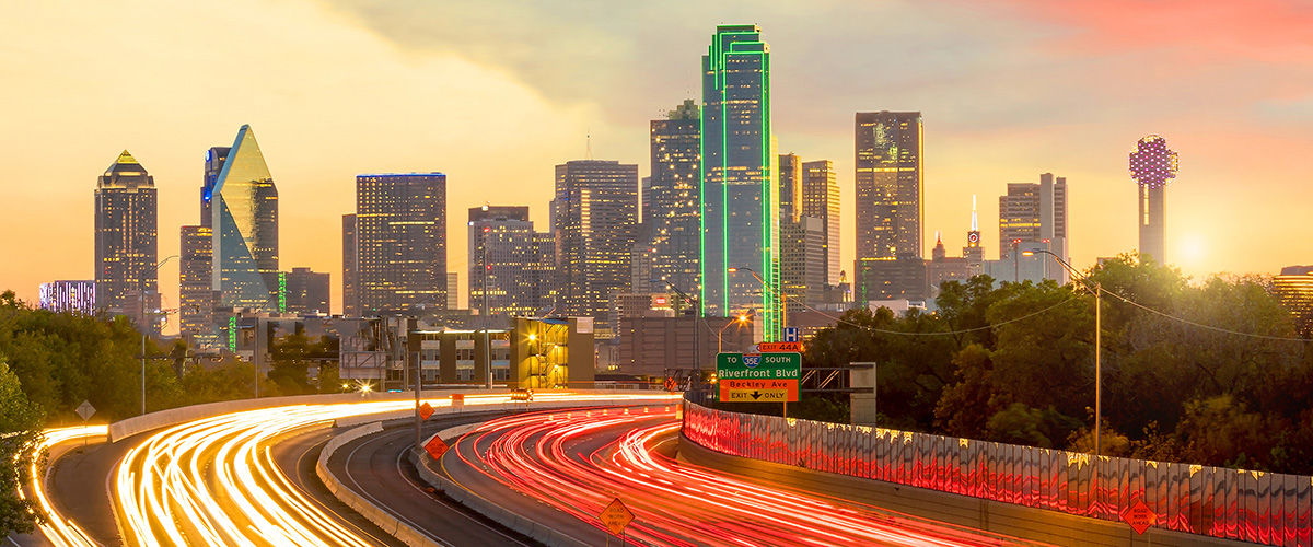 Timelapse view of busy Dallas interstate highway system and downtown skyline